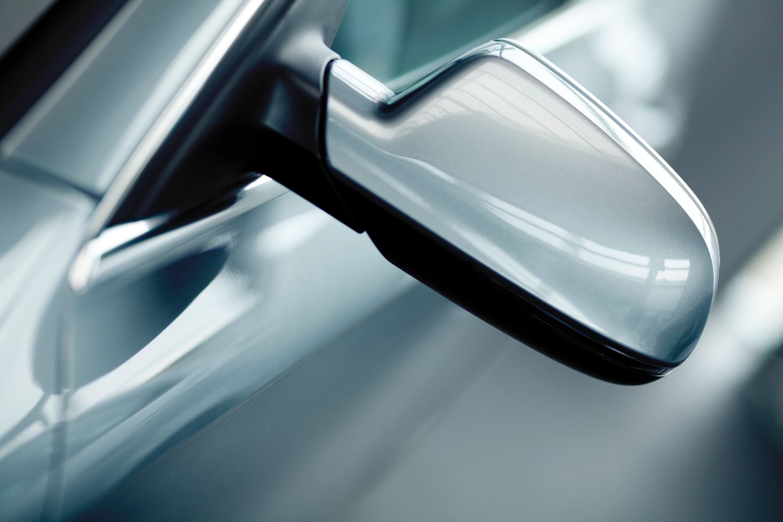 Close-up of modern car side mirror and window