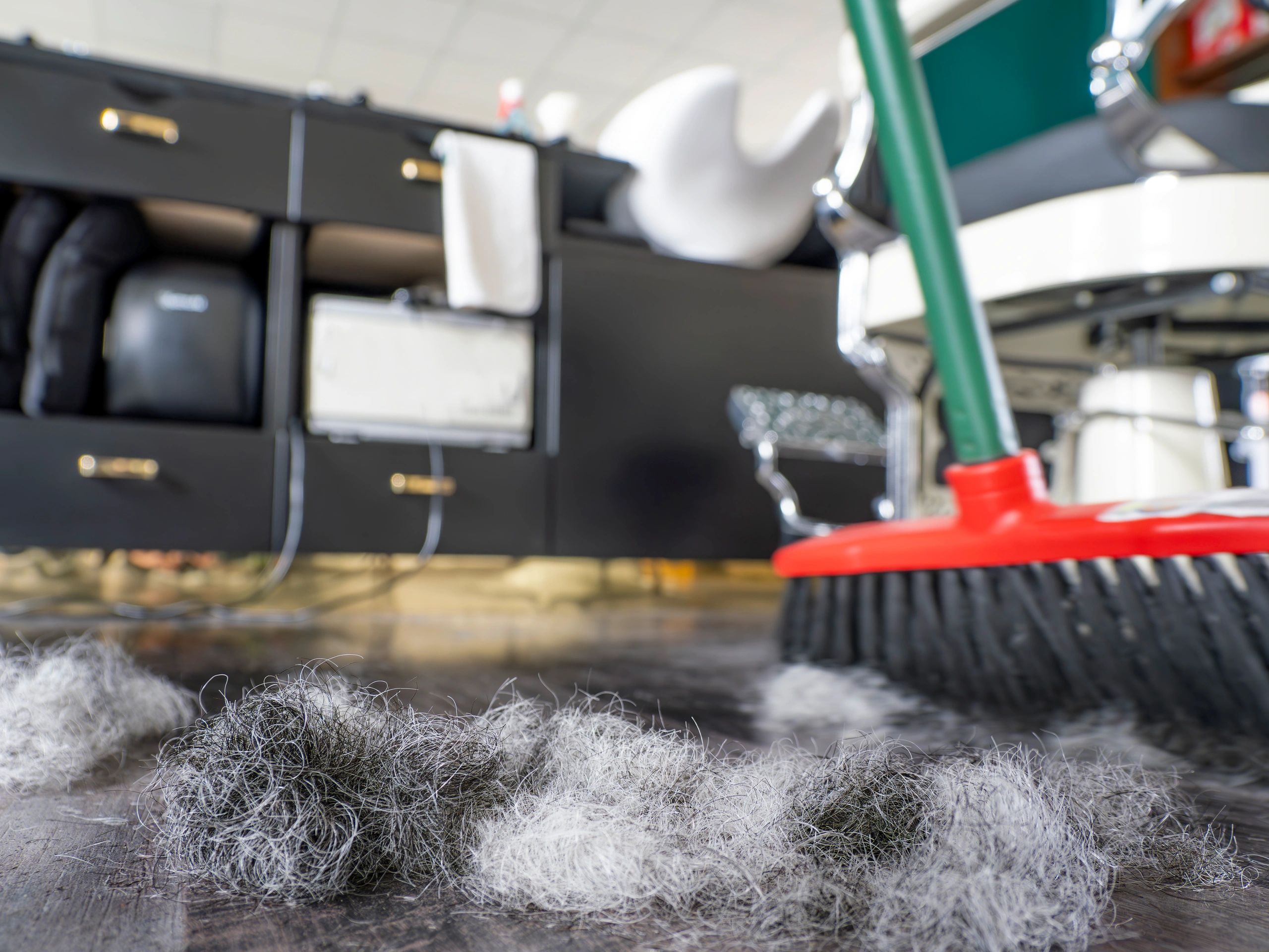 Sweeping hair on the floor at the barbershop