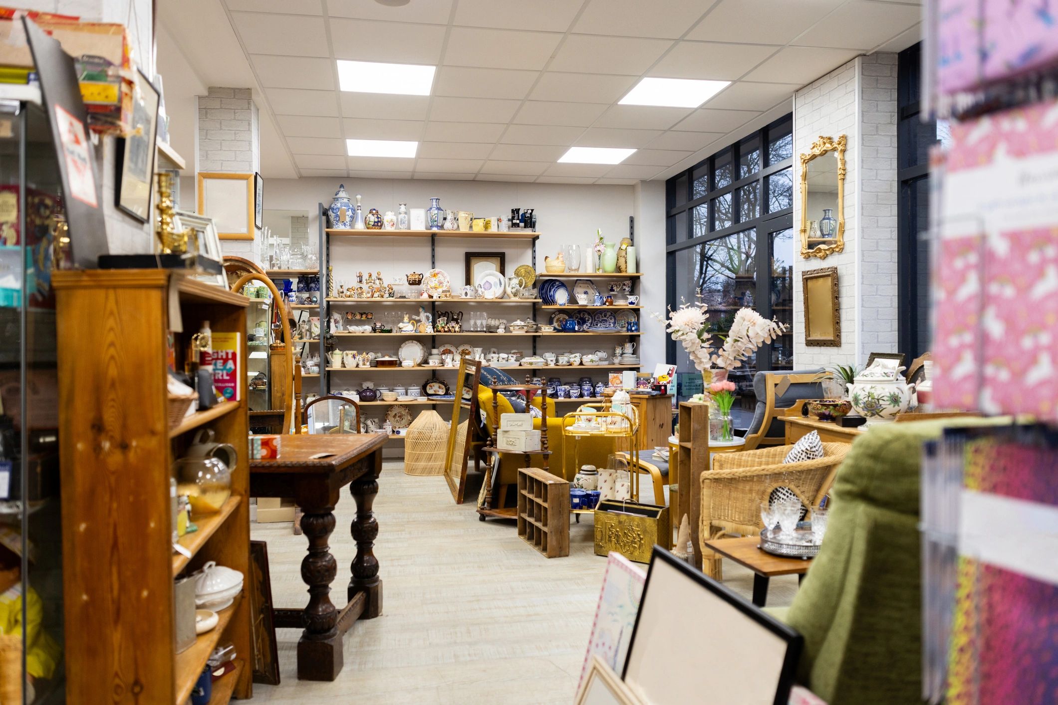 Bright and tidy local shop with goods on display