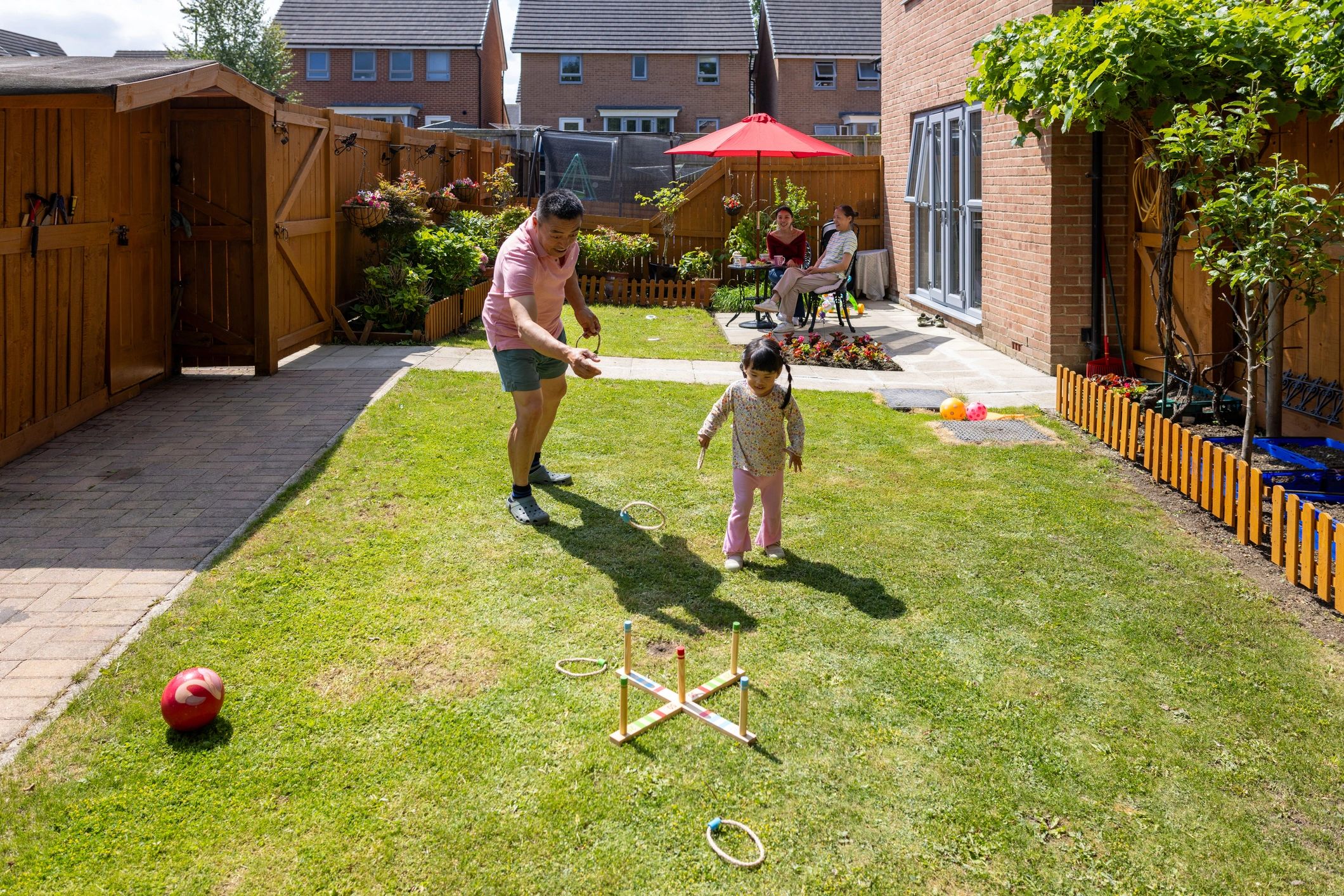 Multi-generation family playing games together outdoors in summer